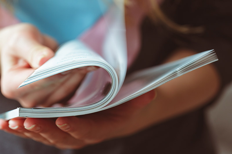 Person flipping through magazine