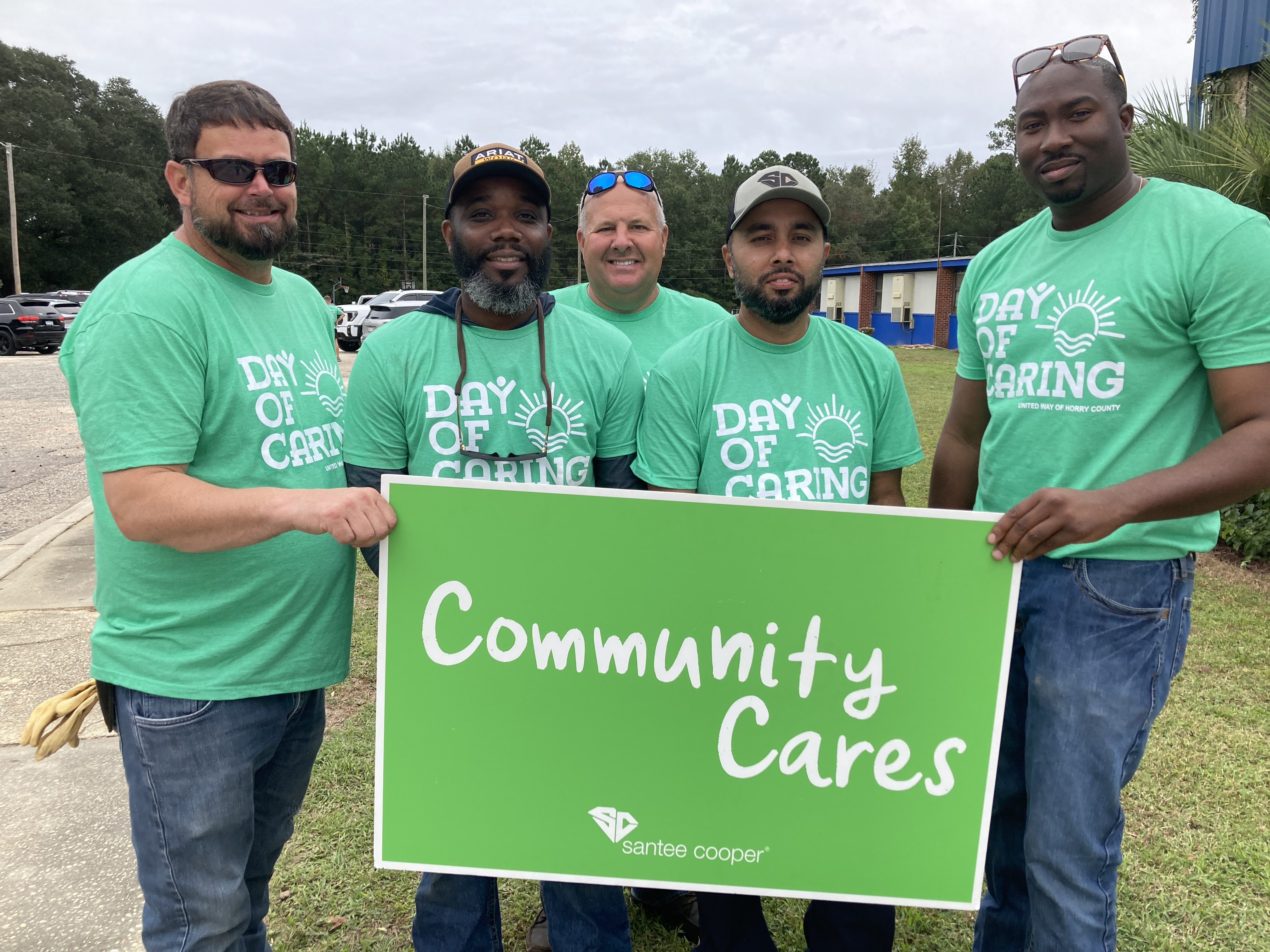 employees holding community cares sign