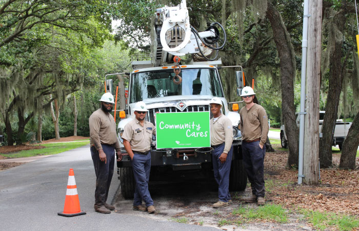 workers holding community cares sign