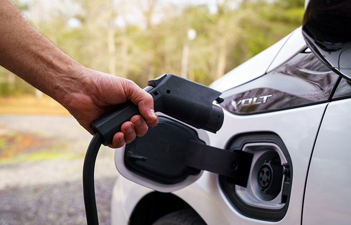 EV driver plugging in to charge