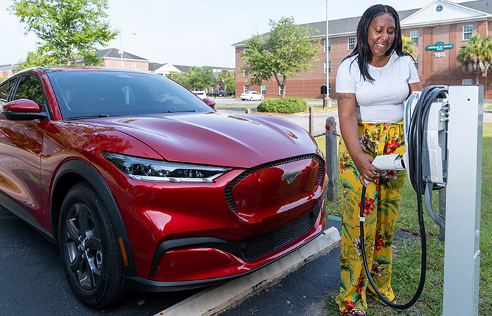 Woman charging her EV