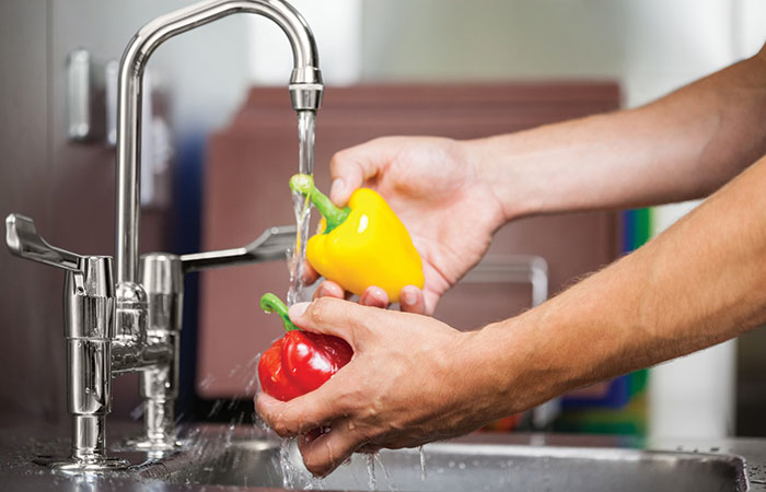 Person washing vegetables