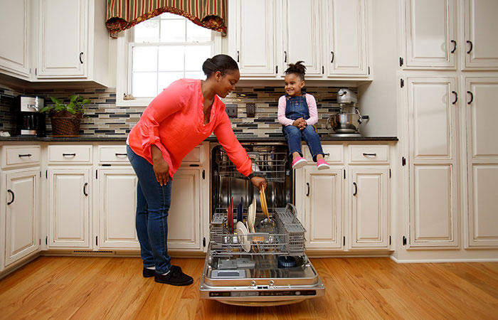 Mom loading dishwasher