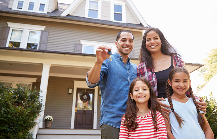 Family standing outside of new home