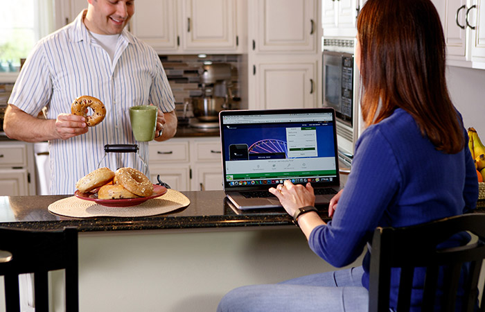 Lady paying bill at kitchen table