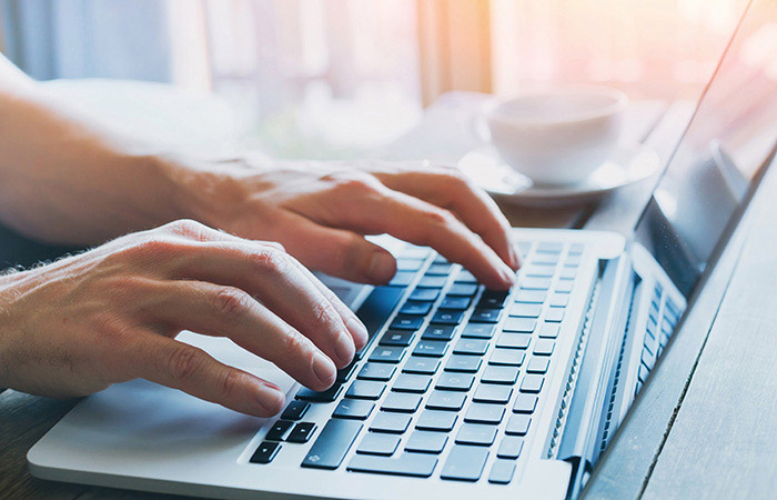 Man typing on laptop