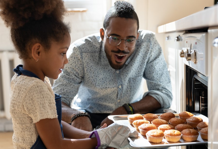 Child baking with adult