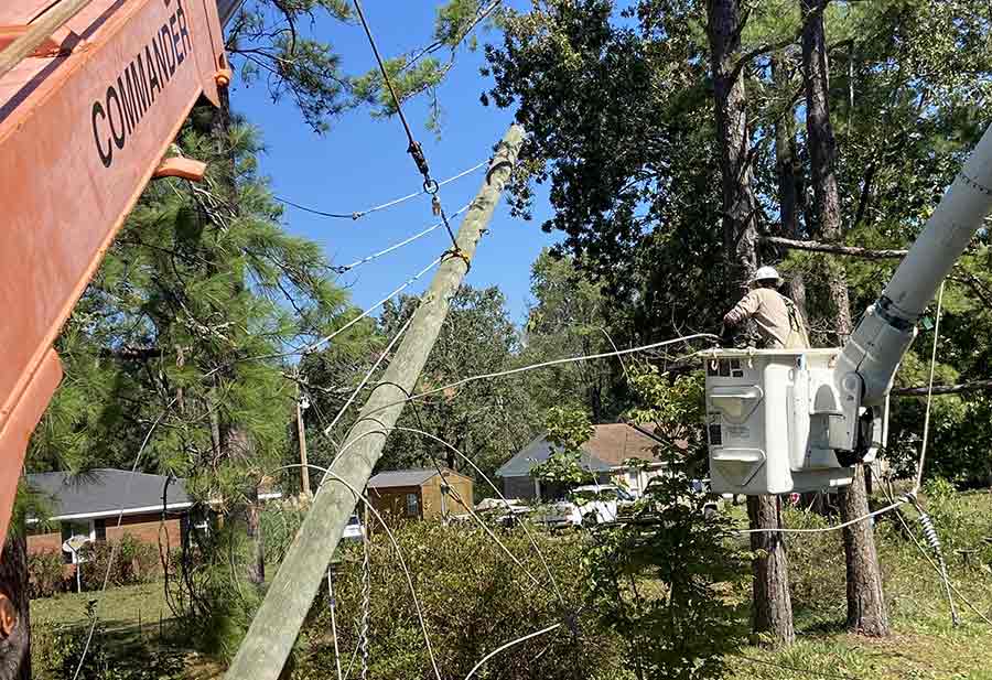 Line technicians work to restore power after Hurricane Helene.